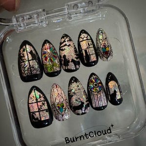 May include: A set of 10 false nails with a stained glass design. The nails are in a clear plastic case with the text "BurntCloud" on the bottom.