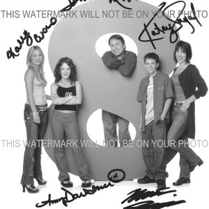 May include: Black and white photo of the cast of the television show "8 Simple Rules" standing in front of a large number eight. The cast members are John Ritter, Katey Sagal, Kaley Cuoco, Amy Davidson, and Martin Spanjers. The show's title is written at the bottom of the photo.
