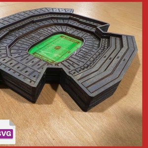 May include: A wooden replica of Levi's Stadium, home of the San Francisco 49ers. The stadium is made of layered wood and features the section numbers of the stadium. The stadium is on a wooden surface.