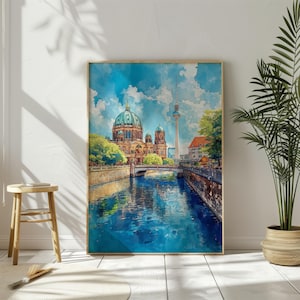 May include: A watercolour painting of the Berlin Cathedral and the Berlin Television Tower, with a canal in the foreground. The painting is framed and hanging on a white wall.