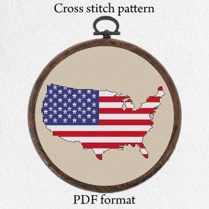 May include: A cross stitch pattern of the United States of America flag in the shape of the country. The pattern is in a wooden hoop and is ready to be stitched. The pattern is in PDF format.