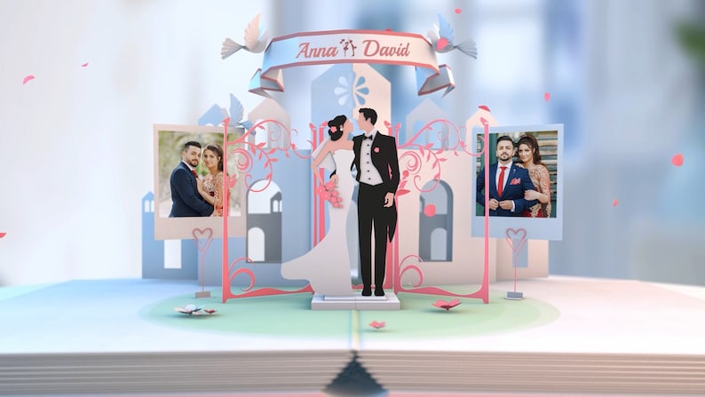 May include: A paper pop-up card with a wedding theme. The card features a couple in a white dress and black suit standing in front of a castle. The card also includes two photos of the couple, one on each side of the castle. The card is decorated with pink and blue flowers and hearts. The text "Anna & David" is written on the top of the card.
