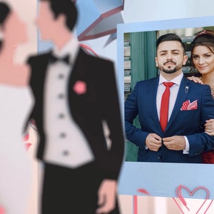 May include: A wedding photo of a couple in formal attire. The groom is wearing a blue suit with a red tie and a white pocket square. The bride is wearing a red dress with gold embroidery. The photo is framed in a blue and white border.