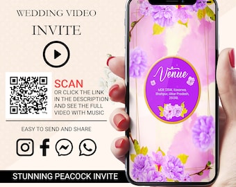 May include: A mobile phone screen displaying a wedding invitation video with a pink and purple floral background. The video is titled "Venue" and includes the address MDR 135W, Kasarwa, Shahpur, Uttar Pradesh, 251318. A QR code is displayed on the left side of the image with the text "SCAN OR CLICK THE LINK IN THE DESCRIPTION AND SEE THE FULL VIDEO WITH MUSIC".