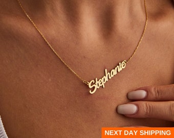 May include: A gold necklace with the name "Stephanie" written in cursive script.