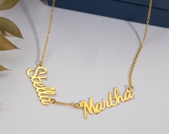 May include: Gold necklace with two names, "Stella" and "Martha", written in a cursive script.