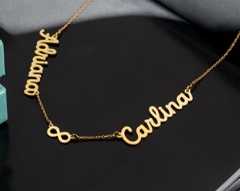 May include: Gold necklace with two names, "Adriana" and "Carlina", connected by an infinity symbol.