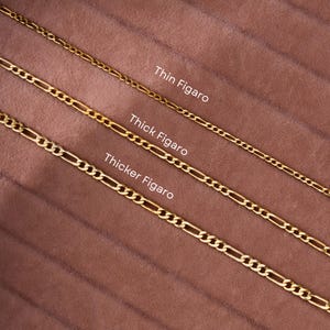 May include: Three gold Figaro chains of different thicknesses, labelled "Thin Figaro", "Thick Figaro", and "Thicker Figaro".