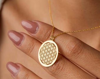 May include: A gold necklace with a round pendant featuring a detailed flower of life design.