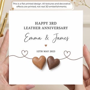 May include: A square greeting card with a white background featuring the text HAPPY 3RD LEATHER ANNIVERSARY, Emma & James, and 12TH MAY 2023. The design includes a thin line with two heart outlines and two printed brown leather-textured hearts.