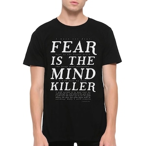 May include: Black t-shirt with white text that reads "FEAR IS THE MIND KILLER" and a quote about fear.
