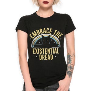 May include: Black t-shirt with a black cat silhouette and the text "Embrace the Existential Dread" in yellow with a rainbow behind the cat.