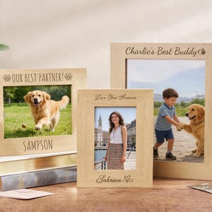 May include: Three wooden photo frames, each with a different image: a dog, a woman, and a boy with a dog. The frames are inscribed with the phrases "Our Best Partner!", "Love You Forever", and "Charlie's Best Buddy".