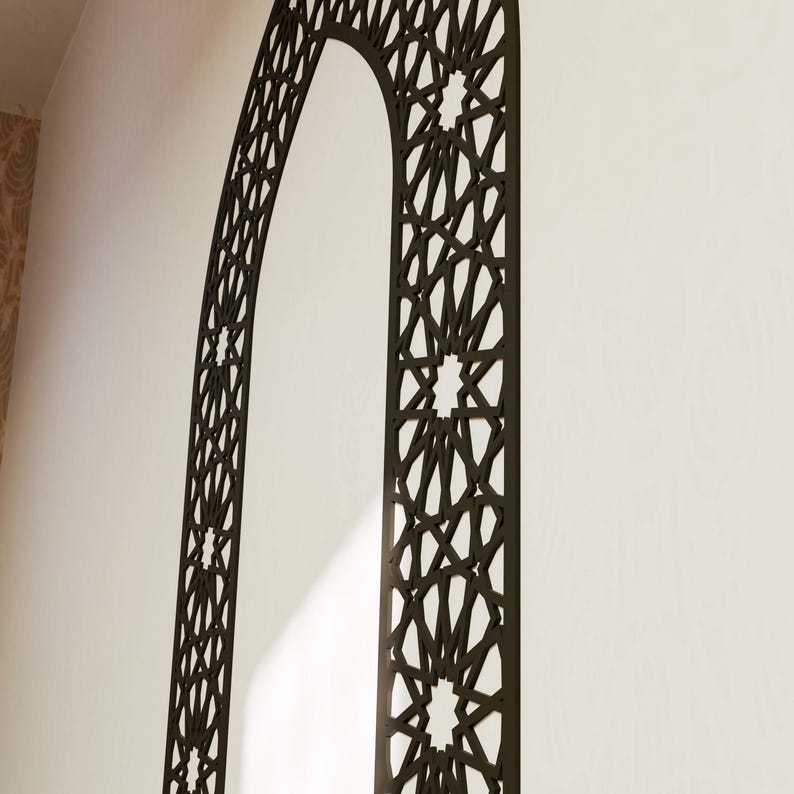 May include: Black metal archway with a geometric pattern, resembling a traditional Islamic design. The archway is mounted on a white wall.