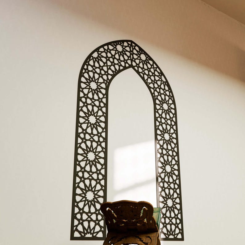 May include: A black and white geometric archway wall decal with a traditional Islamic design. The decal is in the shape of an archway with intricate details.