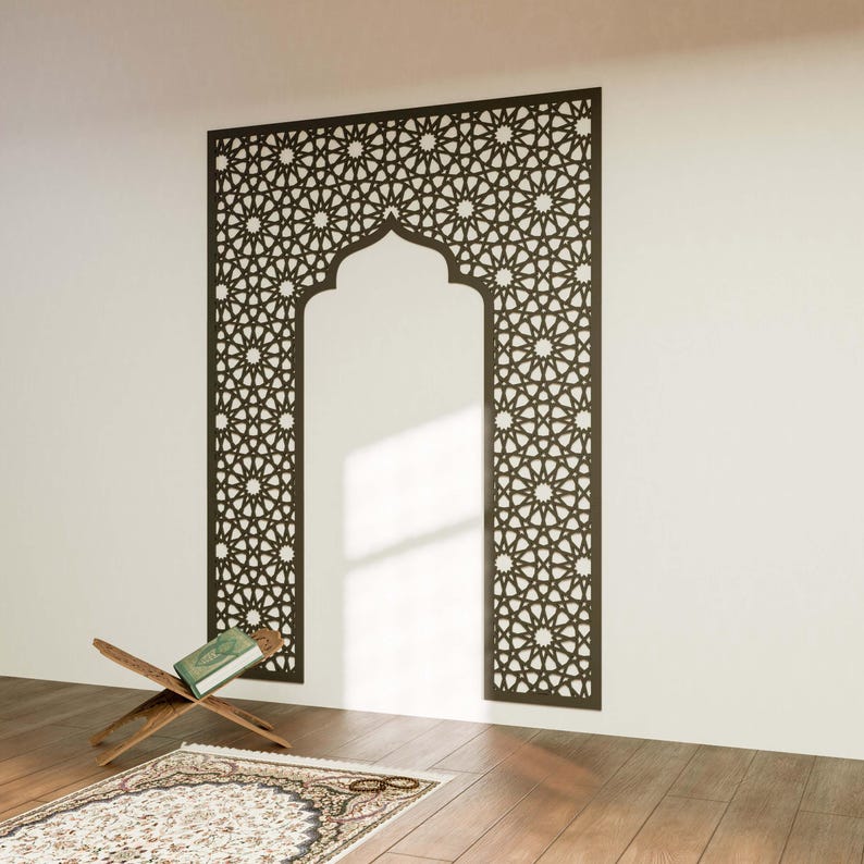 May include: A dark brown, intricately patterned wall panel with an arched top, resembling a doorway. A wooden book stand holds a green book, and a patterned rug lies on the wooden floor. The design features geometric star patterns.
