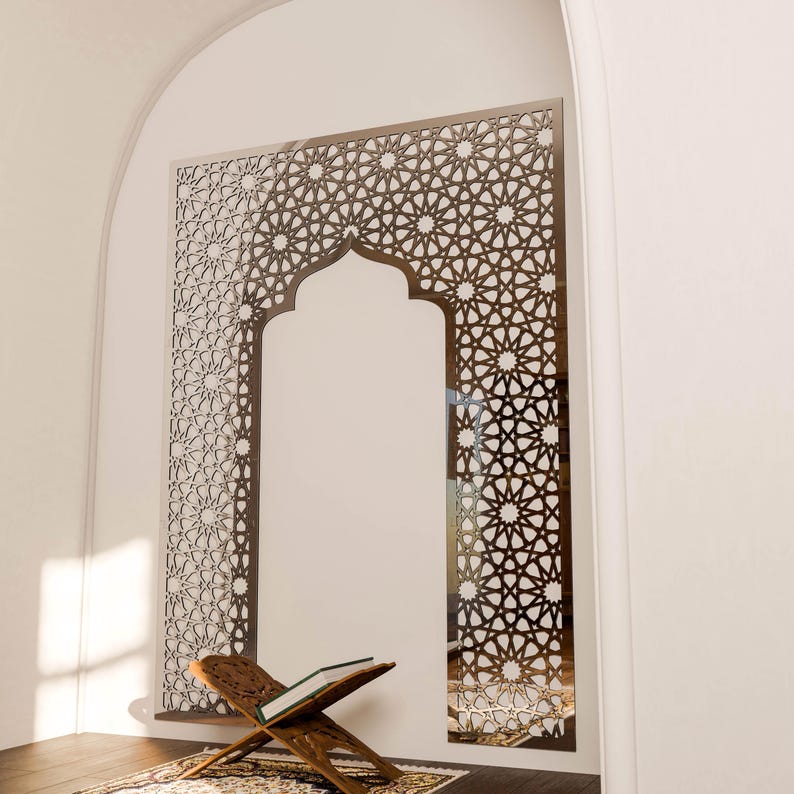 May include: A decorative wall panel featuring a complex geometric design in a warm brown hue. The panel is set within an arched doorway, with a wooden book stand and a patterned rug in the foreground. The design suggests a cultural theme.