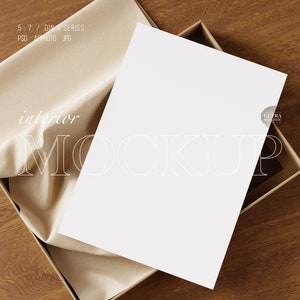 May include: A white sheet of paper inside a brown box with brown tissue paper. The paper has the text "interior MOCKUP" printed on it.