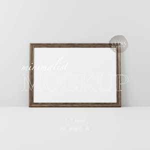 May include: A brown wood frame with a white mat and a white background. The frame is sitting on a white surface. The text "minimalist MOCKUP" is written in white on the frame. The text "3:2 RATIO" is written in white below the frame. The text "PSD AFFPHOTO JPG" is written in white below the ratio text.