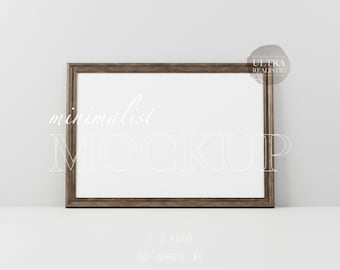 May include: A brown wood frame with a white mat and a white background. The frame is sitting on a white surface. The text "minimalist MOCKUP" is written in white on the frame. The text "3:2 RATIO" is written in white below the frame. The text "PSD AFFPHOTO JPG" is written in white below the ratio text.