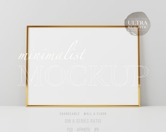 Könnte beinhalten: Rechteckiger Mockup mit goldenem Rahmen und weißem Innenraum. Das Wort "minimalist" ist in einer zarten Schriftart oben geschrieben, darunter "MOCKUP". Zusätzlicher Text enthält "CHANGEABLE WALL & FLOOR", "DIN A SERIES RATIO", "PSD AFPHOTO JPG" und "ULTRA REALISTIC".