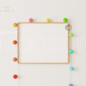 Puede incluir: Una maqueta de marco de madera con fondo blanco. El marco está rodeado de una cadena de luces de bolas de algodón de colores.