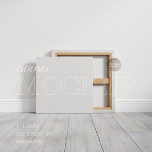 May include: A mockup of a white canvas with a wooden frame, leaning against a white wall. The canvas is blank and ready for your design. The text "canvas MOCKUP" is written in white on the canvas.