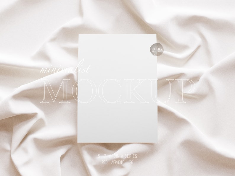 May include: A white card mockup on a white fabric background. The card is blank and has a subtle texture. The fabric is smooth and has a slight sheen. The text "minimalist MOCKUP" is visible in the image.