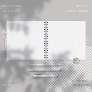 May include: A white notebook mockup with a spiral binding, open to reveal blank pages. The notebook is on a gray background with shadows of leaves. Three pencils and a pen are also included in the mockup.