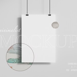 May include: A white poster mockup hanging from a string with a gray background. The poster is blank and has a subtle shadow. The text "minimalist MOCKUP" is written in white on the left side of the image. The text "ULTRA REALISTIC" is written in white on a gray circle on the right side of the image. The text "CHANGEABLE WALL 5:7 RATIO PSD AFFPHOTO JPG" is written in white at the bottom of the image.