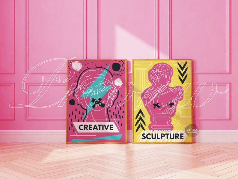 May include: Two framed prints with a pink background. The print on the left features a stylized line drawing of a woman's face with a lightning bolt and the word "CREATIVE". The print on the right features a stylized line drawing of a bust sculpture with the word "SCULPTURE".