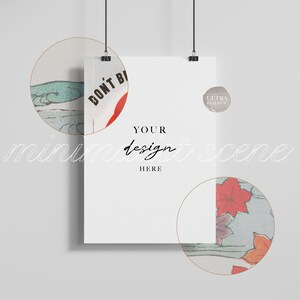 May include: A white poster mockup hanging from two clips with the text "YOUR design HERE" in black. The poster is surrounded by two circular frames with a Japanese-inspired design featuring blue and green waves, red flowers, and the text "DON'T BE" in red.