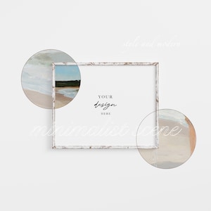 May include: White wooden frame with a distressed finish, perfect for displaying your artwork or photos. The frame is surrounded by two circular watercolor paintings of a beach scene.
