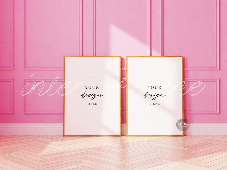 May include: Two gold framed posters with white backgrounds against a pink wall. The text "YOUR DESIGN HERE" is written on each poster.