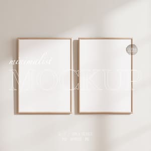 May include: Two minimalist wood framed mockups with white mats on a white wall with a shadow from a window. The text "minimalist MOCKUP" is written in white on the wall.