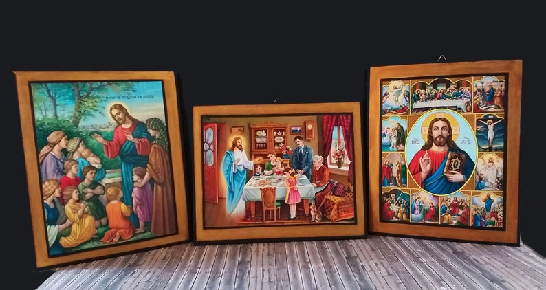 May include: Three framed religious paintings depicting scenes from the life of Jesus Christ. The paintings are on a wooden background and feature a gold frame. The first painting shows Jesus teaching children. The second painting shows Jesus at a table with people. The third painting shows Jesus in the centre of a grid of nine smaller paintings, each depicting a different scene from the life of Jesus.