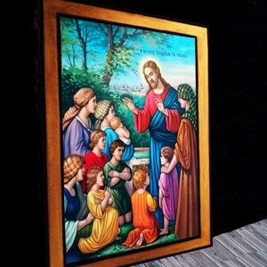 May include: A framed painting depicting Jesus Christ with children. The painting is set in a garden with a well in the background. The text "&Omicron; &Kappa;&Upsilon;&Rho;&Iota;&Omicron;&Sigma; &Epsilon;&Upsilon;&Lambda;&Omicron;&Gamma;&Epsilon;&Iota; &Tau;&Alpha; &Pi;&Alpha;&Iota;&Delta;&Iota;&Alpha;" is written at the top of the painting.