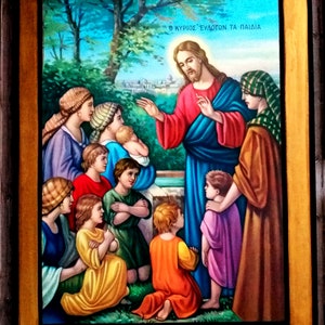 May include: A painting depicting Jesus Christ with children. The painting is framed in gold and features a blue sky with green trees in the background. The text "&Omicron; &Kappa;&Upsilon;&Rho;&Iota;&Omicron;&Sigma; &Epsilon;&Upsilon;&Delta;&Omicron;&Kappa;&Iota;&Mu;&Epsilon;&Iota; &Tau;&Alpha; &Pi;&Alpha;&Iota;&Delta;&Iota;&Alpha;" is written at the top of the painting.