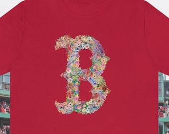 May include: Red t-shirt with a floral design of the letter "B".
