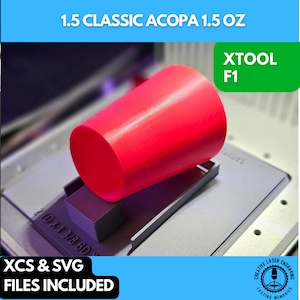 May include: A red plastic cup sits on a gray platform with the text "21D X 1 3/8 BD" visible. The cup is labeled "1.5 Classic Acopa 1.5 oz" and "XTOOL F1". The image also includes the text "XCS & SVG FILES INCLUDED" and a logo for "Creative Laser Engraving, Lasting Memories".