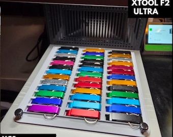Op de afbeelding: Een display van 36 aluminium flesopeners in diverse kleuren, waaronder zwart, roze, blauw en rood. De tekst "36 ALUMINUM BOTTLE OPENER" staat bovenaan, met "XTOOL F2 ULTRA" rechts en "XCS FILES INCLUDED" onderaan.