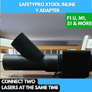 May include: Black plastic Y-shaped adapter for connecting two laser cutters simultaneously. The adapter is labeled "SAFETYPRO XTOOL INLINE Y ADAPTER" and "F1 U, M1, S1 & MORE".
