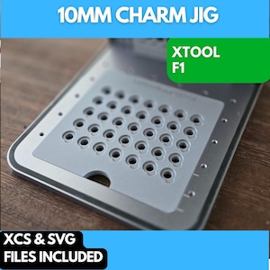 May include: A silver 10mm charm jig with a gray insert featuring multiple holes for making charms. The jig is labeled "XTOOL F1".
