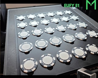 May include: A black rectangular tray with thirty-five circular indentations holding white and black poker chips. The text 40 MM COIN AND POKER CHIP, EUFY E1, and FOR UV PRINTERS is visible. A small printer is shown in the bottom right corner.