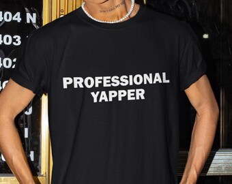 May include: Black t-shirt with white text that reads "PROFESSIONAL YAPPER".