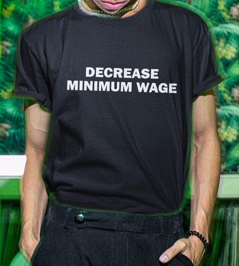 May include: A black t-shirt with the text "DECREASE MINIMUM WAGE" printed in white.