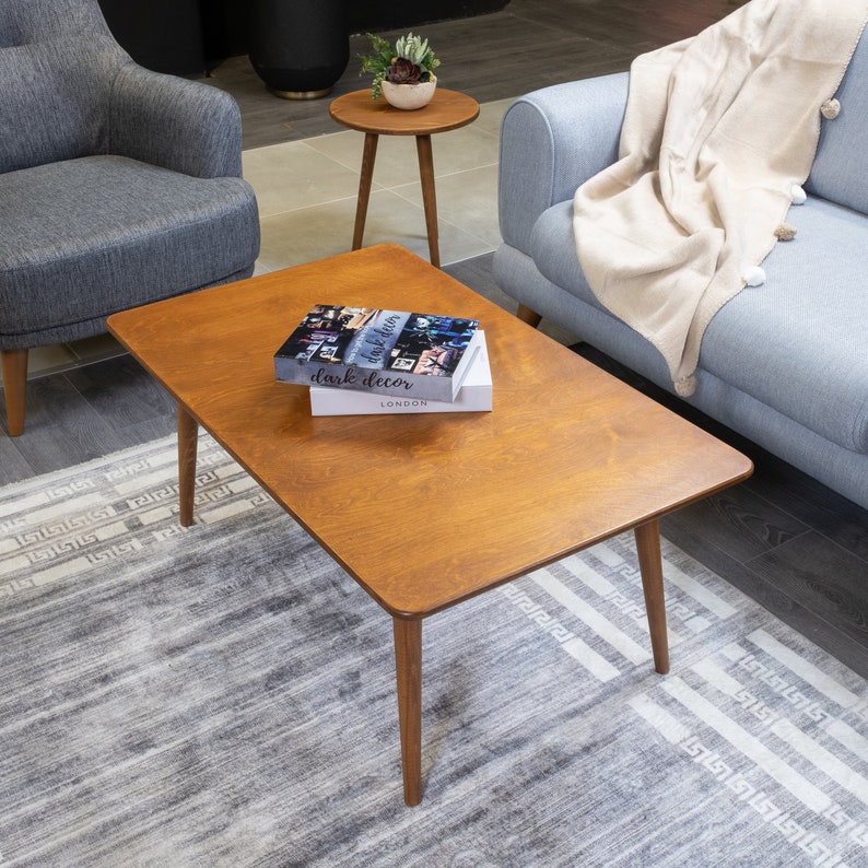 Discover the Modern Oval Coffee Table for your home! This versatile walnut coffee table, made from pine wood, fits seamlessly with any living room furniture.