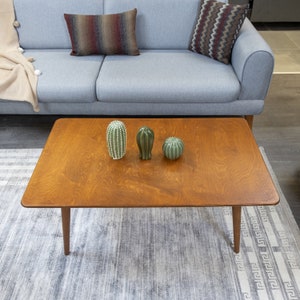 Discover the Modern Oval Coffee Table for your home! This versatile walnut coffee table, made from pine wood, fits seamlessly with any living room furniture.
