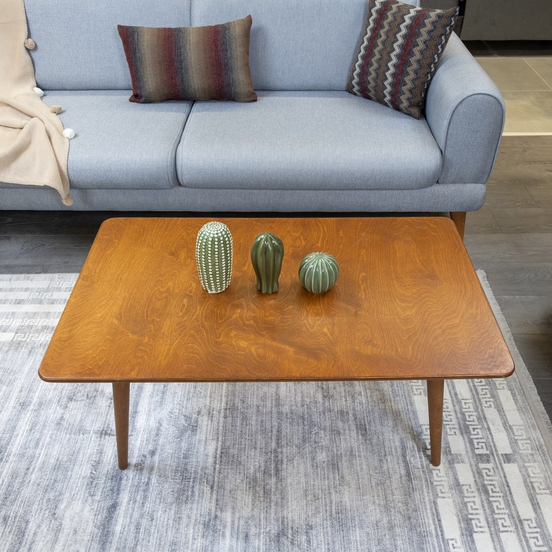 Discover the Modern Oval Coffee Table for your home! This versatile walnut coffee table, made from pine wood, fits seamlessly with any living room furniture.
