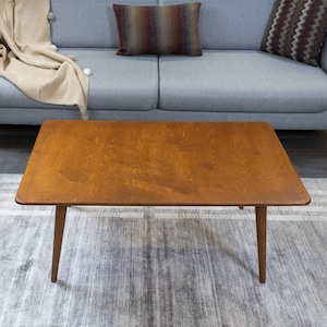 Discover the Modern Oval Coffee Table for your home! This versatile walnut coffee table, made from pine wood, fits seamlessly with any living room furniture.